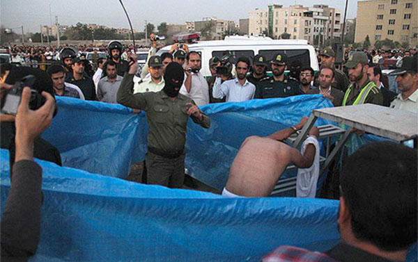 Iran: prisoner lashed in public moments before being hanged.