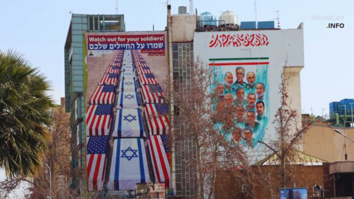 A road in Tehran lined with a large billboard displaying anti-U.S. and anti-Israel messages.